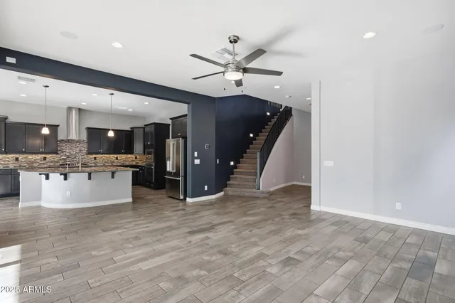 a large kitchen with stainless steel appliances kitchen island a large counter top and a sink