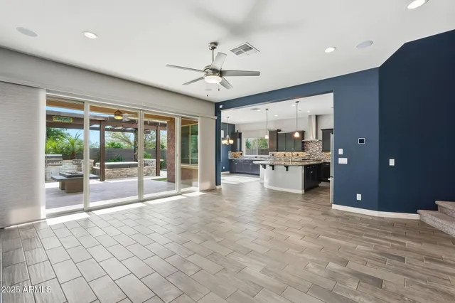 a large white kitchen with granite countertop a large window and a fireplace