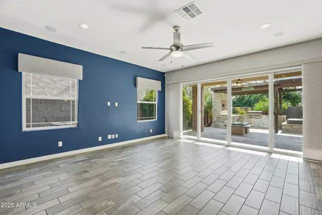 a view of an empty room with a window and a kitchen