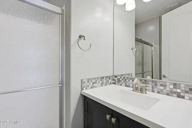 a bathroom with a sink and a mirror