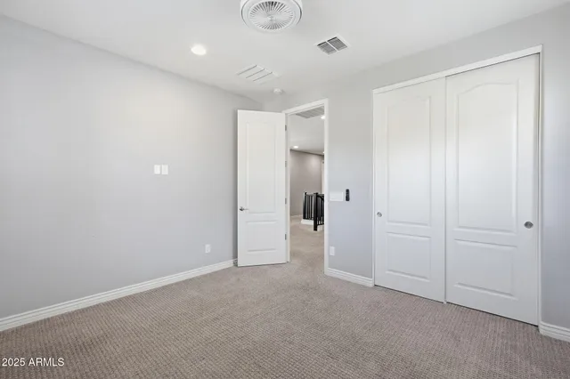 an empty room with closet area