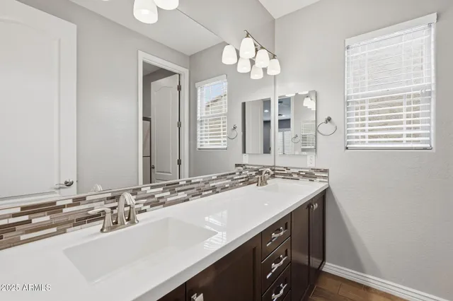 a bathroom with a sink double vanity and a mirror