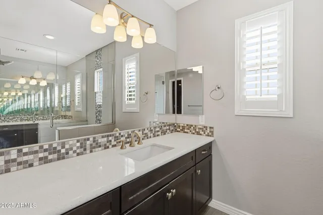a bathroom with a sink double vanity and a mirror