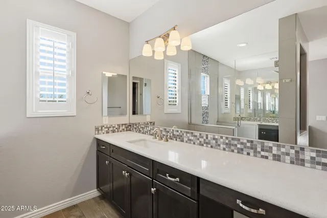 a bathroom with a sink double vanity and a mirror