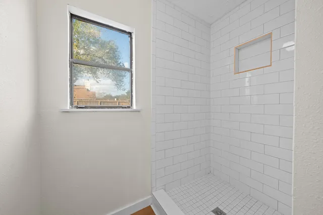 a view of a livingroom with wooden floor and white walls
