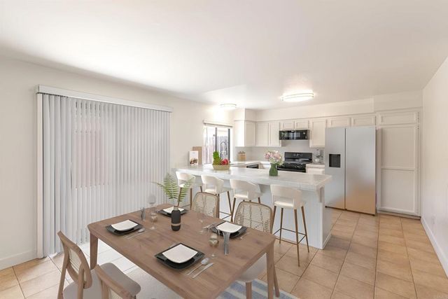 a view of a dining room with furniture and a kitchen