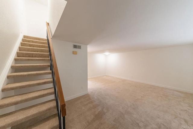 an empty room with a bathroom and a sink