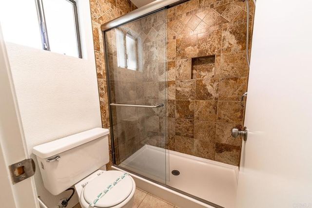 a bathroom with a sink mirror bathtub and toilet