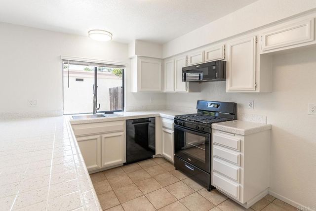 a kitchen with stainless steel appliances granite countertop a stove and a sink
