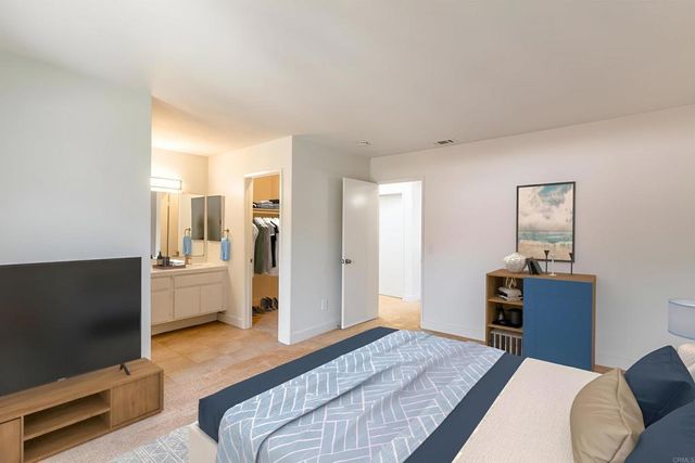 a bedroom with bed and a potted plant