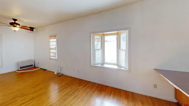 a view of a room with wooden floor and cabinet