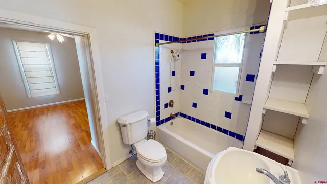 a white toilet sitting next to a small sink