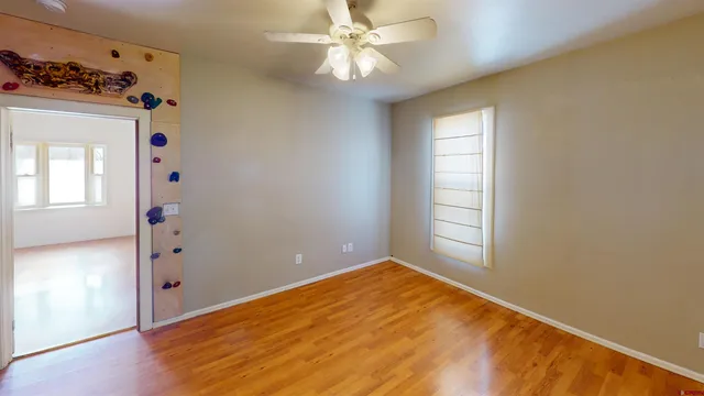 wooden floor in an empty room with a window