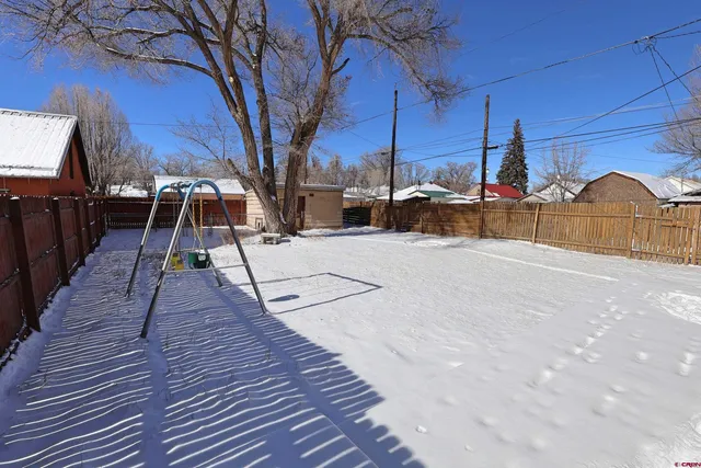 a view of a house with a snow in the yard