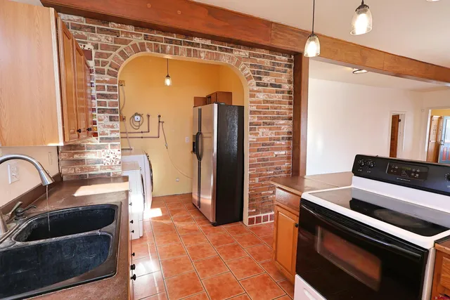 a kitchen with a stove and a refrigerator