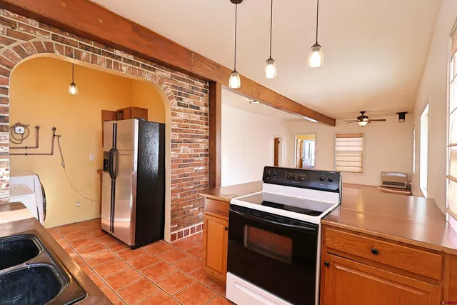a kitchen with stainless steel appliances granite countertop a refrigerator and a stove