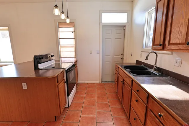 a kitchen that has a sink and a stove