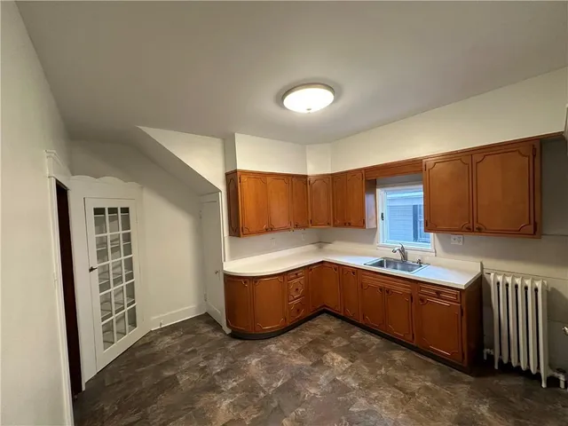 a kitchen with sink cabinets and window