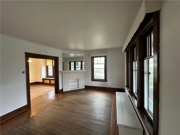 a view of a livingroom with wooden floor and a window