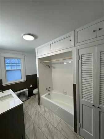 a bathroom with a bathtub and a shower