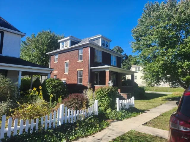 a front view of house and yard with green space
