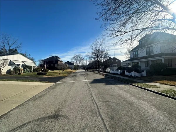 a view of street with parked cars