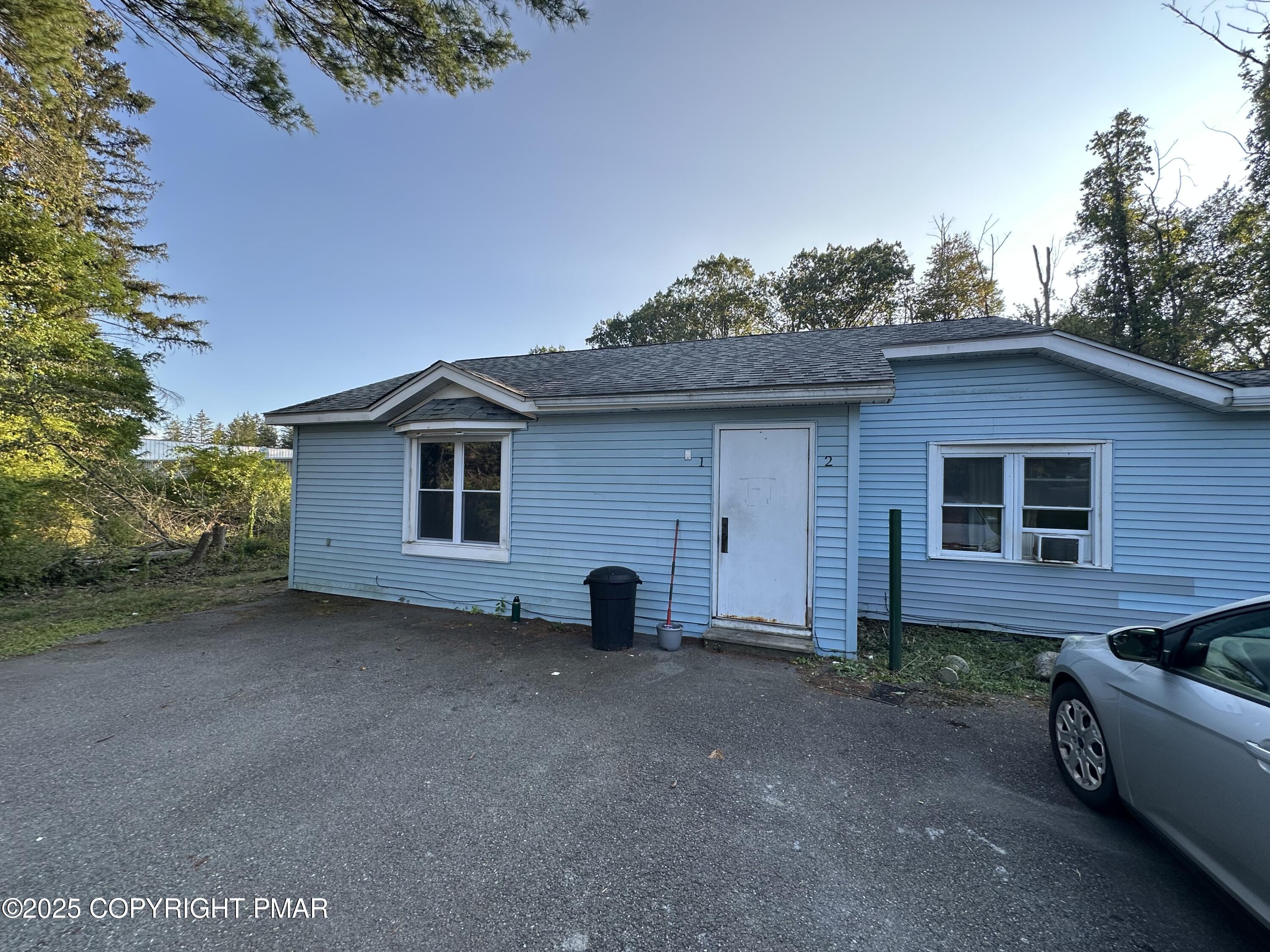 a view of house with backyard