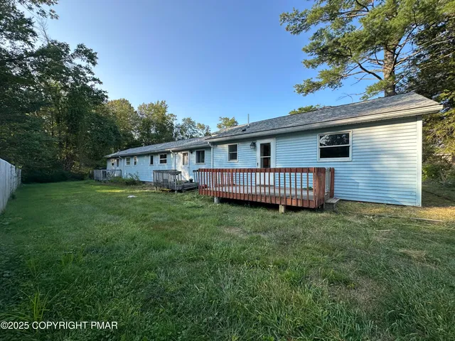a view of a house with a backyard