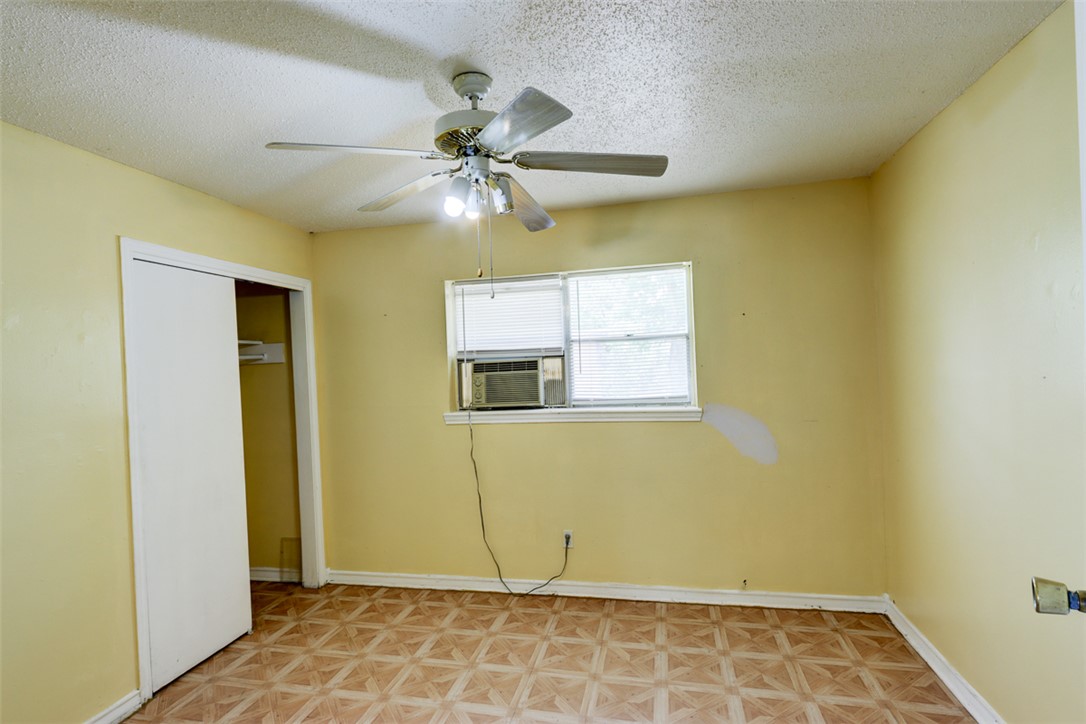 2402 Wilkes Street Bryan, TX 77803 - Photo 12 of 24 a view of an empty room with wooden floor and a window