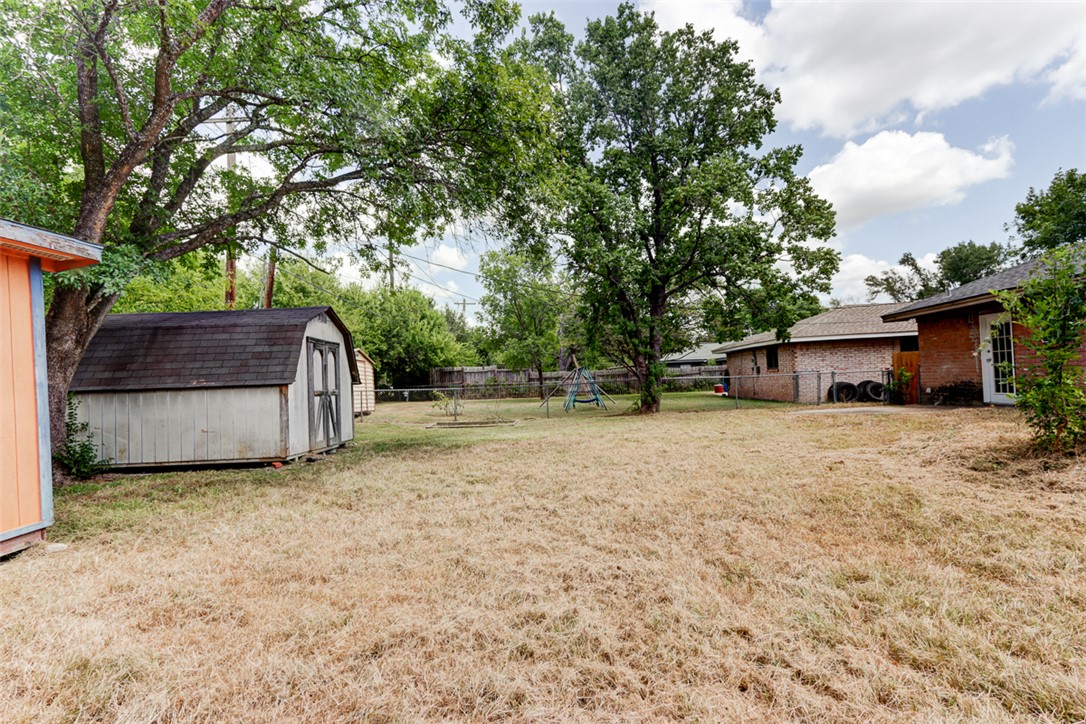 2402 Wilkes Street Bryan, TX 77803 - Photo 23 of 24 a view of a house with backyard and a tree