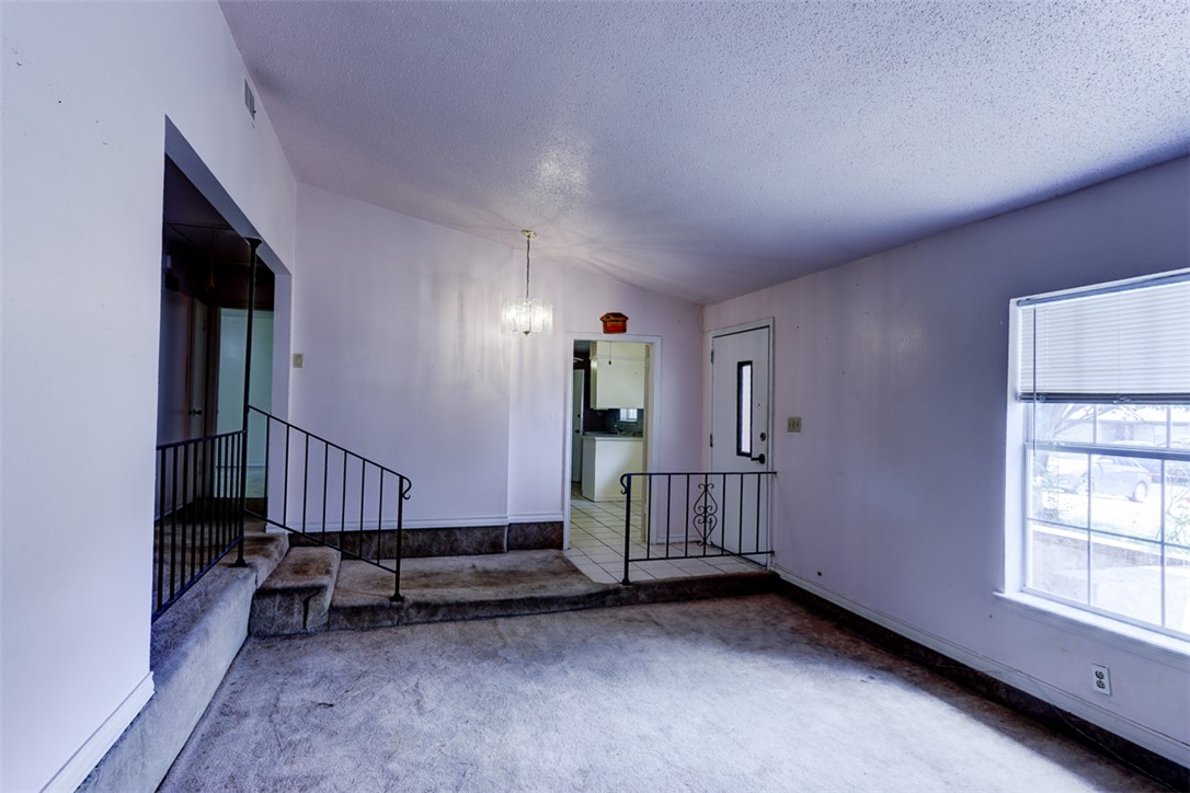 2402 Wilkes Street Bryan, TX 77803 - Photo 4 of 24 an empty room with wooden floor and windows