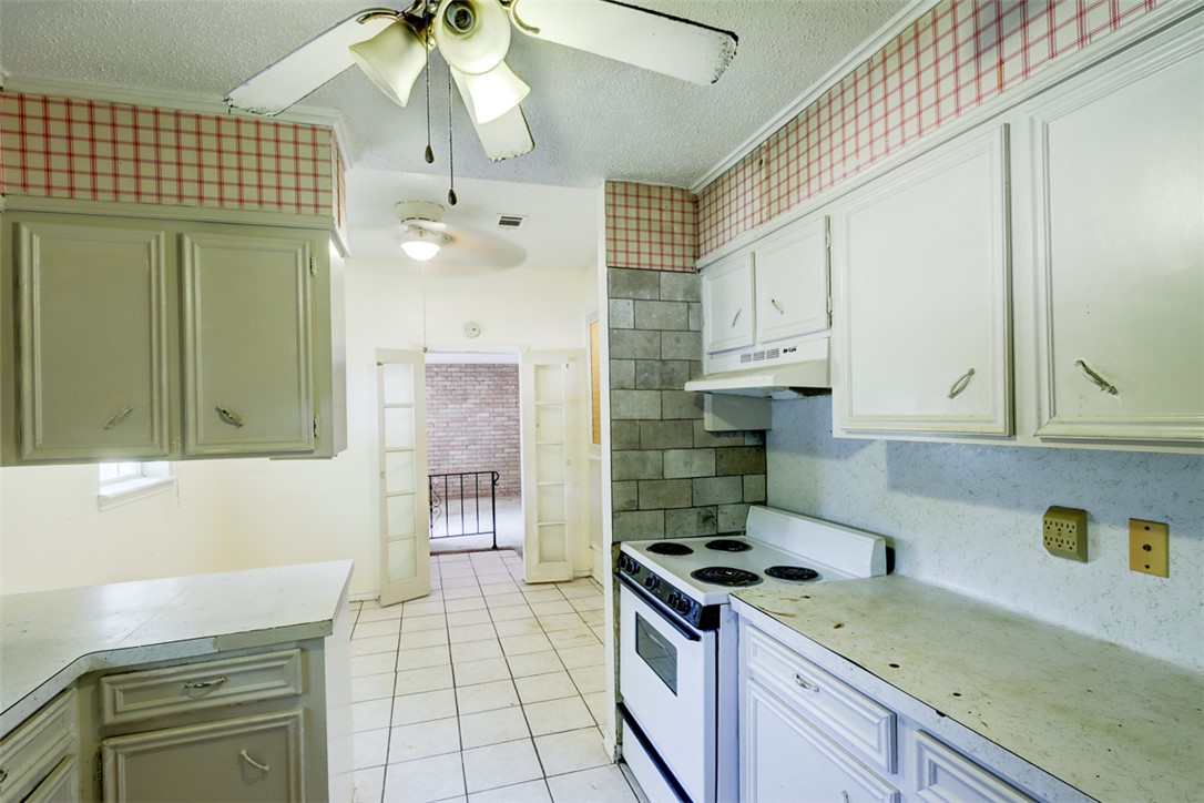 2402 Wilkes Street Bryan, TX 77803 - Photo 8 of 24 a kitchen with a sink stove and cabinets