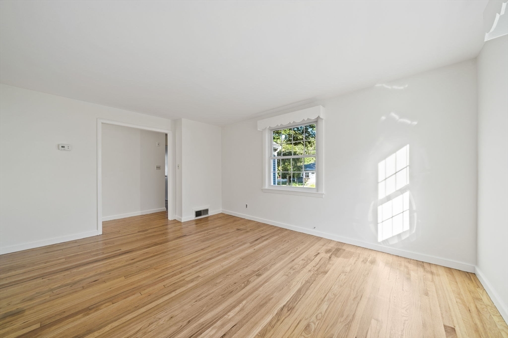 7 Drake Street Braintree, MA 02184 - Photo 11 of 26 a view of an empty room with wooden floor and a window
