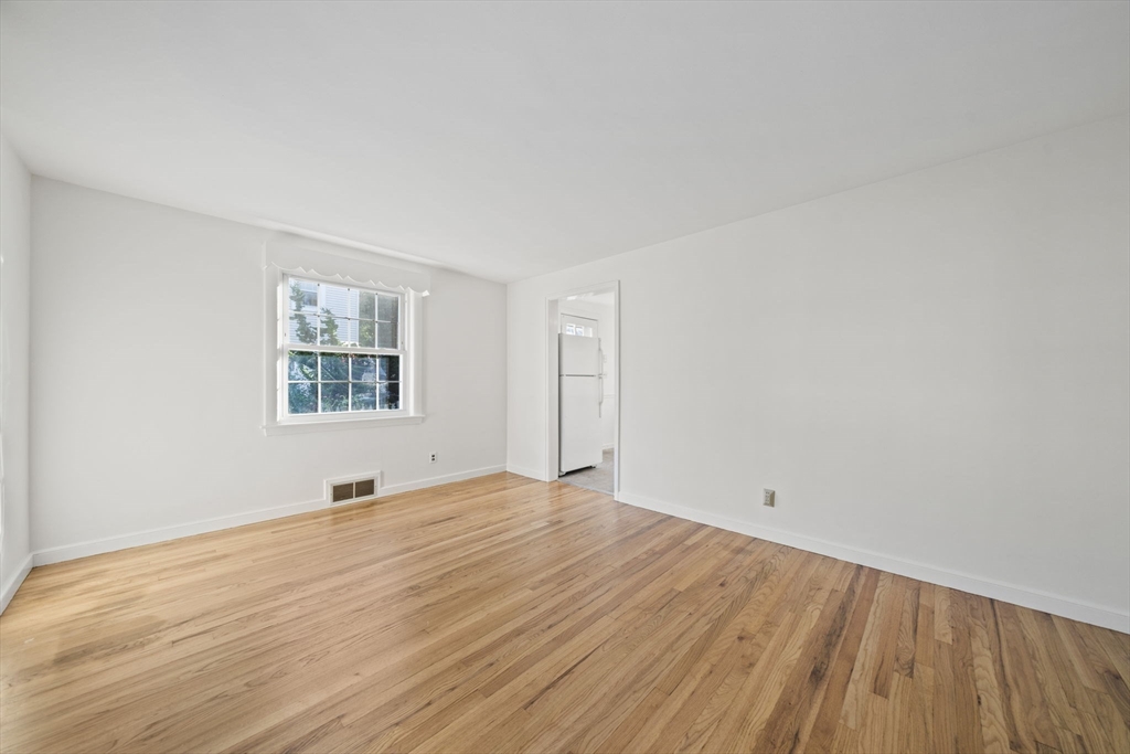 7 Drake Street Braintree, MA 02184 - Photo 12 of 26 an empty room with wooden floor and windows