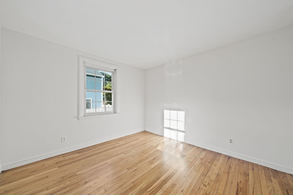 7 Drake Street Braintree, MA 02184 - Photo 14 of 26 an empty room with wooden floor and windows