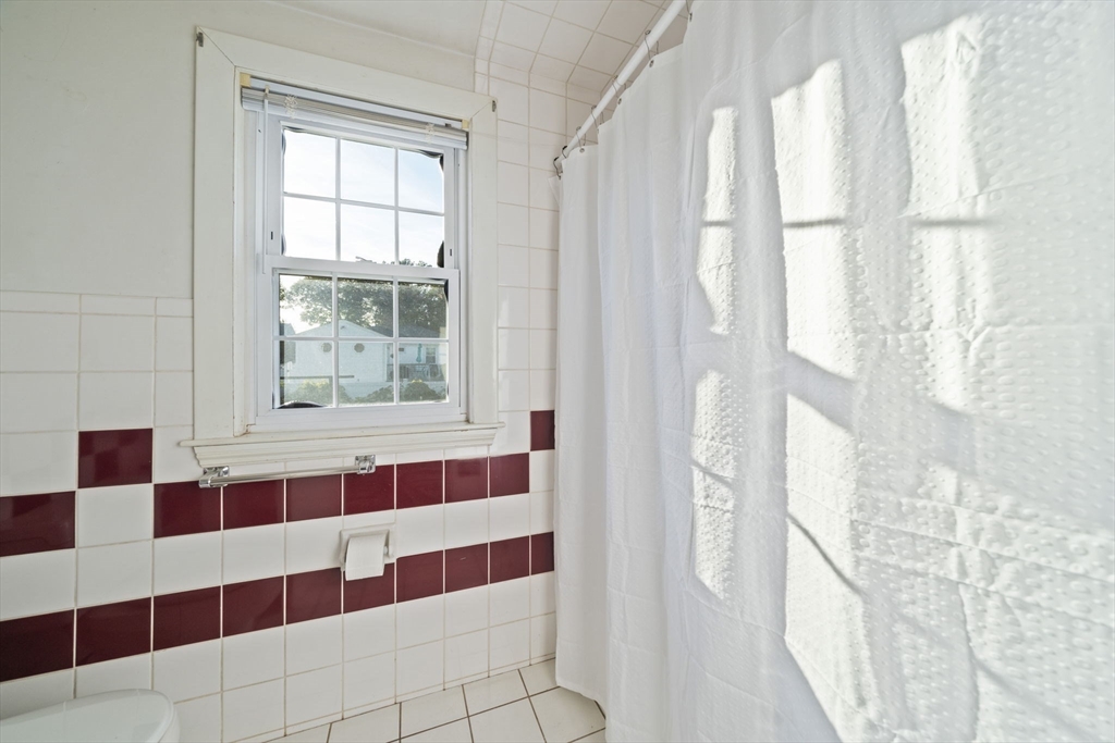 7 Drake Street Braintree, MA 02184 - Photo 16 of 26 a view of a bathroom with a shower and a window