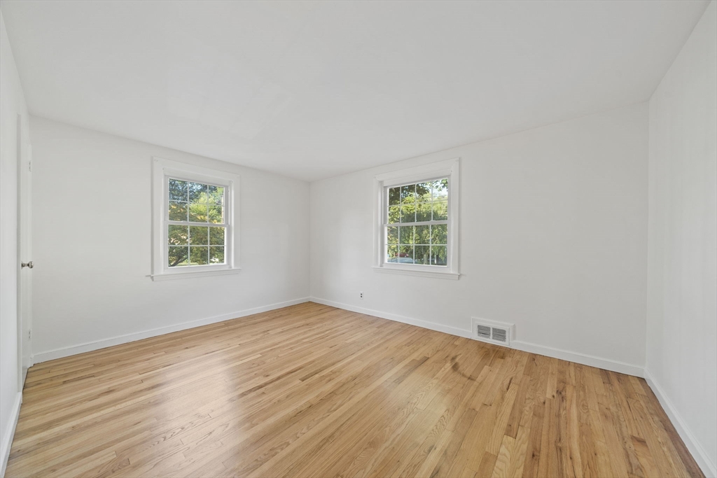 7 Drake Street Braintree, MA 02184 - Photo 18 of 26 an empty room with wooden floor and windows