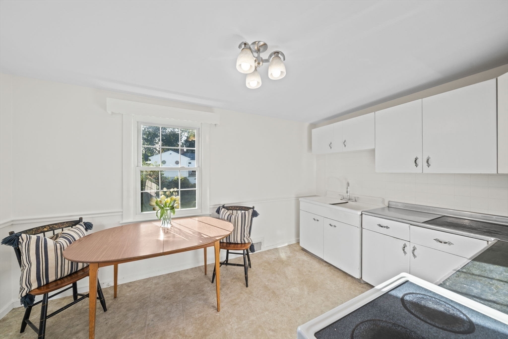7 Drake Street Braintree, MA 02184 - Photo 7 of 26 a view of a kitchen with a dining table chairs and a window