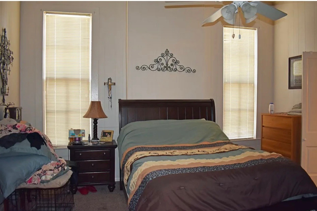 735 Center Street Henderson, KY 42420 - Photo 12 of 14 a bedroom with a bed and wooden floor