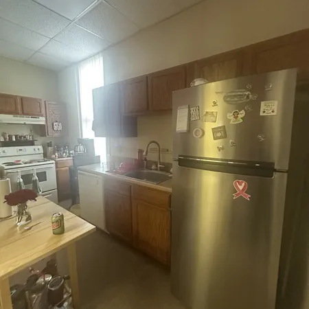 a kitchen with a sink appliances and cabinets