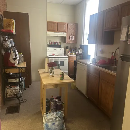 a kitchen with a sink appliances and cabinets