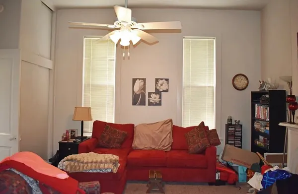 a living room with furniture a chandelier and a window
