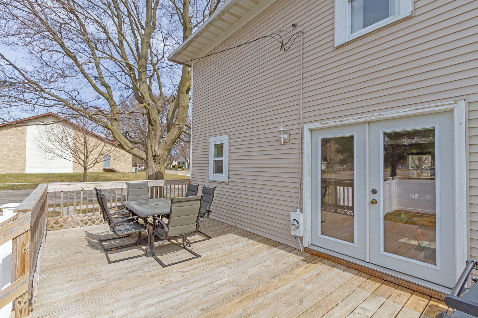 728 Woolf Court Rochelle, IL 61068 - Photo 20 of 31 a roof deck with table and chairs and wooden floor