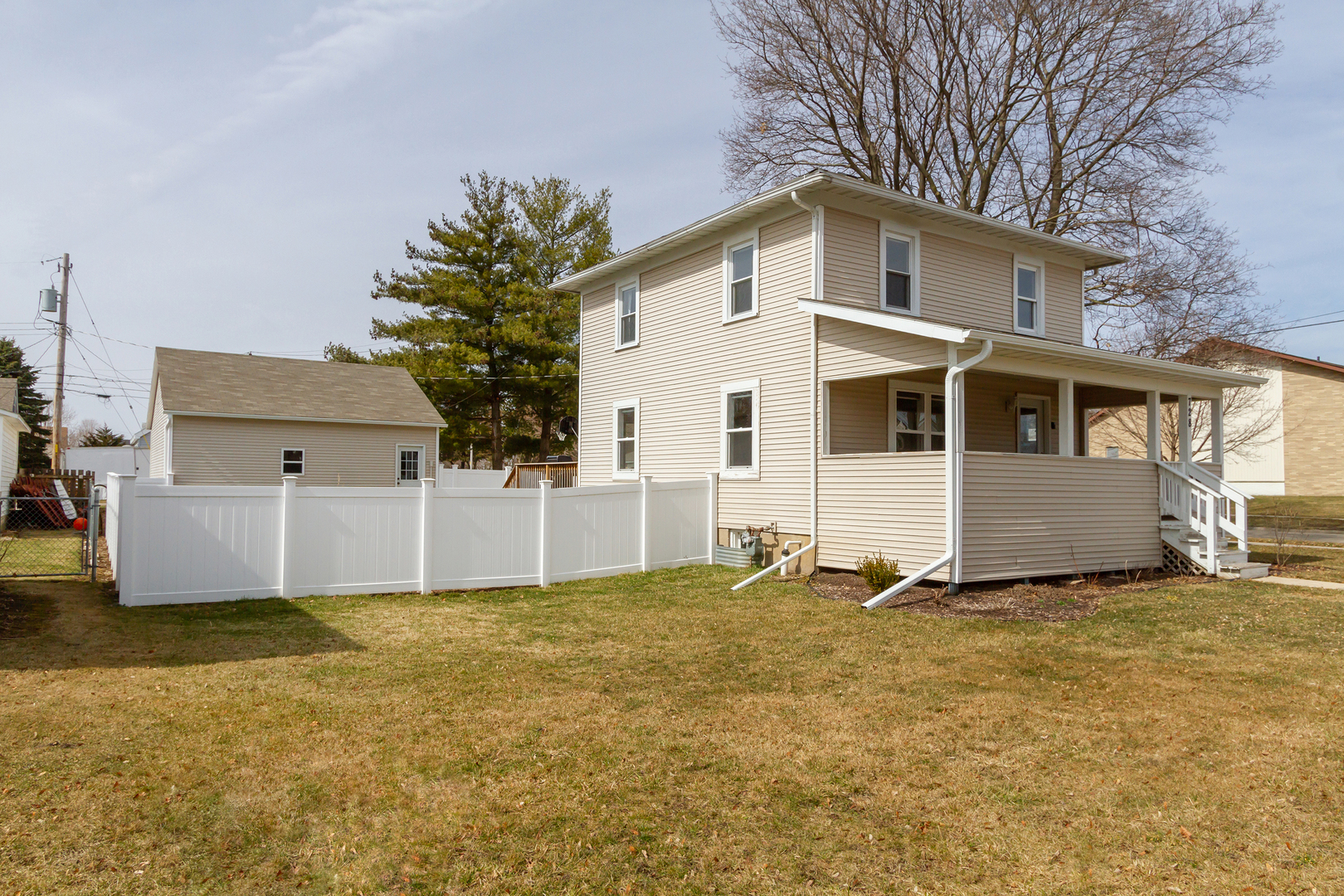 728 Woolf Court Rochelle, IL 61068 - Photo 29 of 31 a white house that has a big yard and more windows