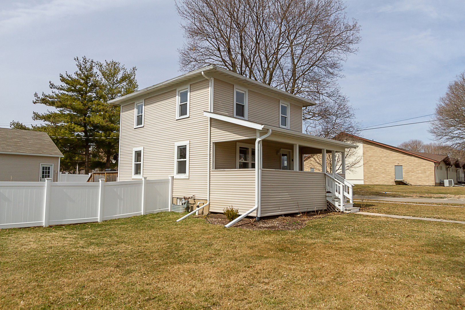 728 Woolf Court Rochelle, IL 61068 - Photo 31 of 31 a white house that has a tree in front of it