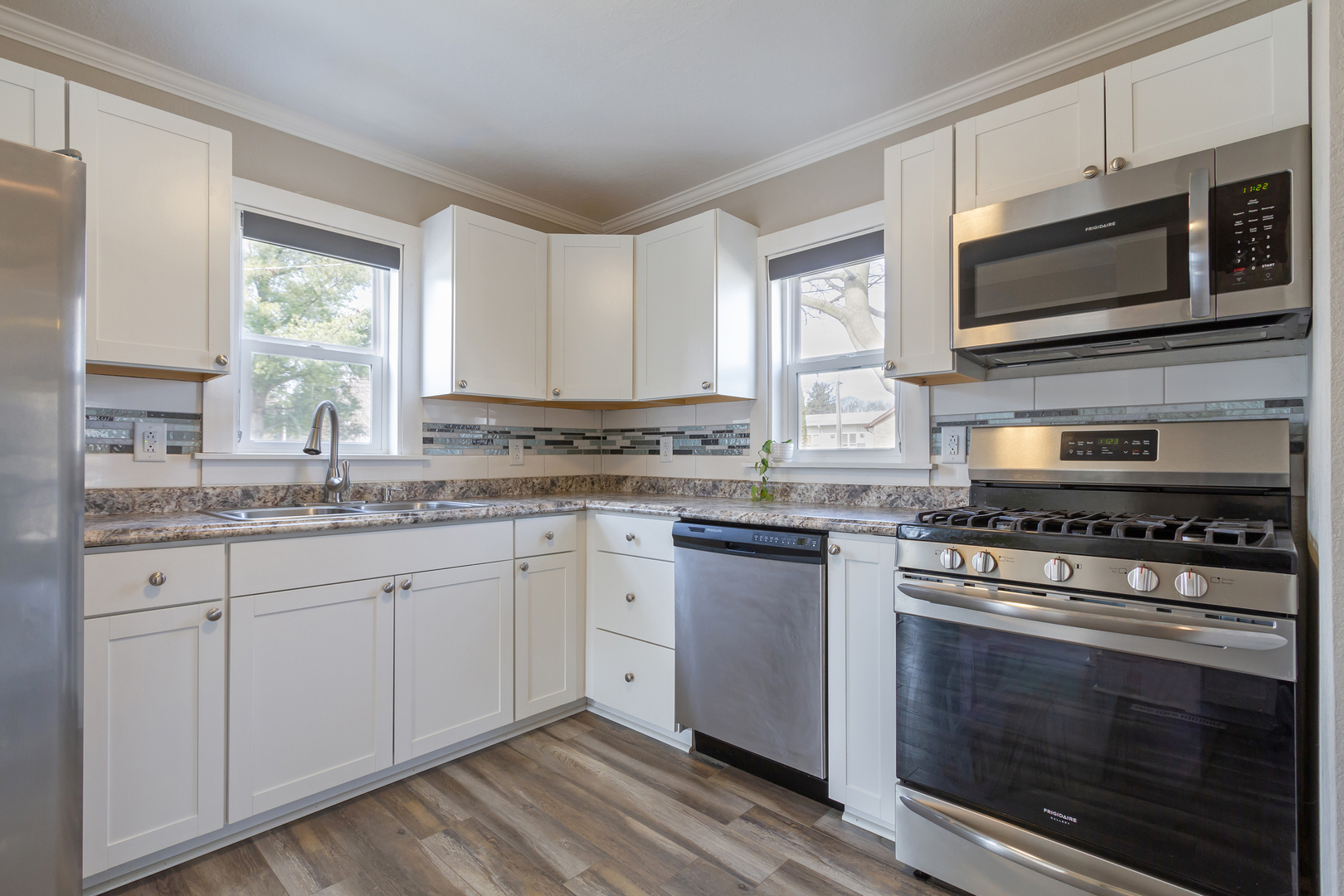 728 Woolf Court Rochelle, IL 61068 - Photo 10 of 31 a kitchen with stainless steel appliances granite countertop a stove microwave and sink