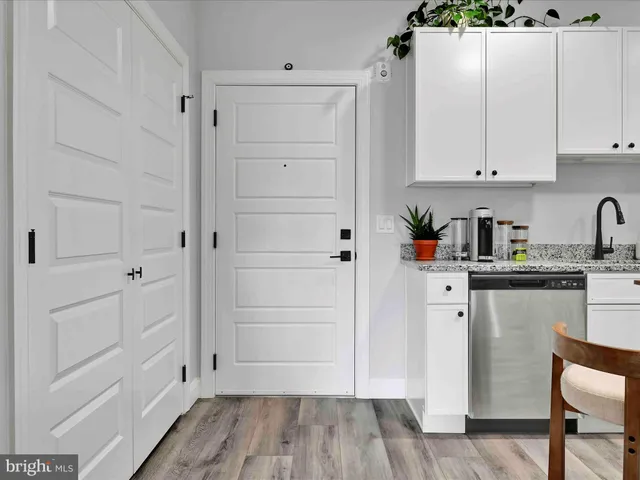 a kitchen with stainless steel appliances kitchen island granite countertop a kitchen island a stove a refrigerator a stove a dining table and chairs