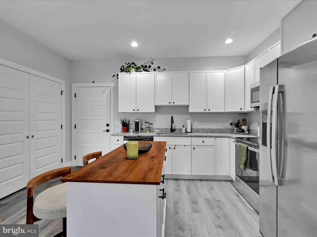 a bathroom with a granite countertop sink toilet and a mirror