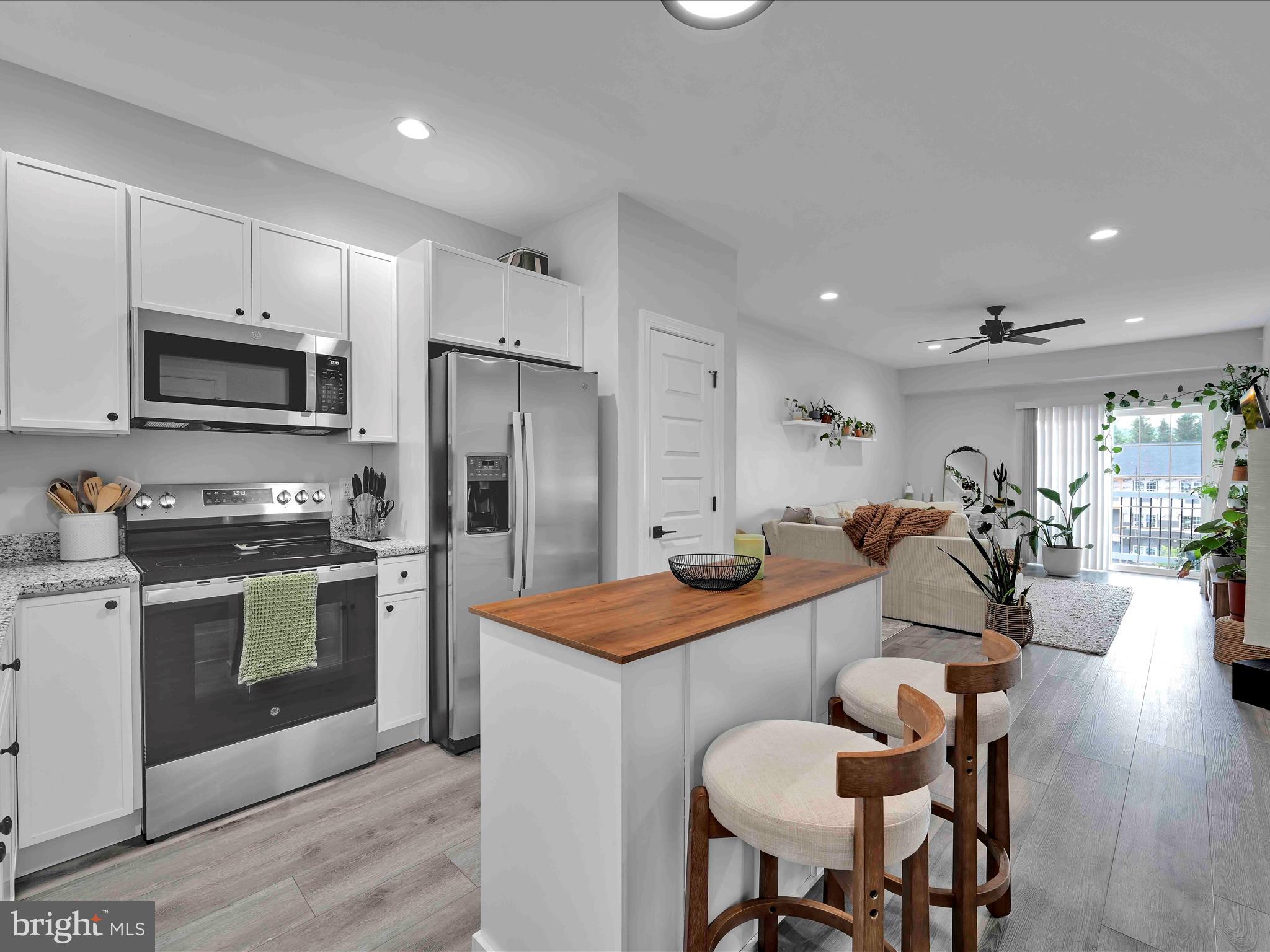 500-800 Paramount Boulevard, Unit 101312 Orwigsburg, PA 17961 - Photo 15 of 66 a kitchen with stainless steel appliances kitchen island granite countertop a kitchen island a stove a refrigerator a stove a dining table and chairs