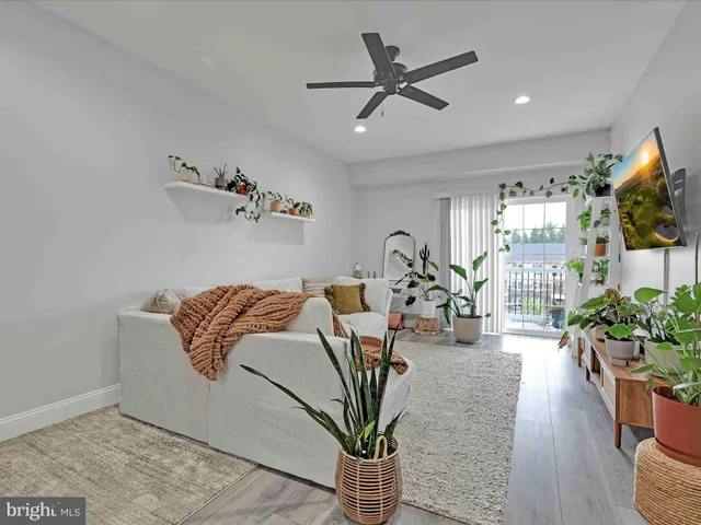a kitchen with wooden floors stainless steel appliances and white cabinets